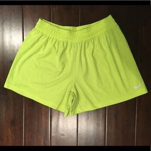 Neon yellow Nike shorts. Waist folds over w/ tie